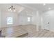 Bright living room features wood-look flooring and a modern chandelier at 1101 Oak Knoll Ter, Atlanta, GA 30315