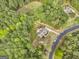 Breathtaking aerial shot showcasing a home surrounded by verdant trees and a winding road at 100 Chantilly Ln, Fayetteville, GA 30215
