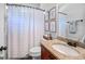 Bright bathroom featuring a granite countertop vanity, toilet, framed art and shower with striped curtain at 100 Chantilly Ln, Fayetteville, GA 30215