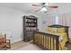 Cozy bedroom featuring plush bedding and a ceiling fan that provides a comfortable atmosphere at 100 Chantilly Ln, Fayetteville, GA 30215