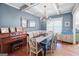 Dining room showcases coffered ceilings, elegant chandelier, and natural light at 100 Chantilly Ln, Fayetteville, GA 30215