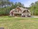 Charming two-story home featuring stone and shingle accents, manicured landscaping, and an inviting walkway at 100 Chantilly Ln, Fayetteville, GA 30215