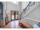Bright, two-story foyer with wood-look floors, decorative bench, and plenty of natural light at 100 Chantilly Ln, Fayetteville, GA 30215