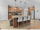 Spacious kitchen with granite counters, island, stainless appliances, and pendant lighting at 100 Chantilly Ln, Fayetteville, GA 30215