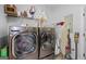 Well-organized laundry room features modern washer and dryer with storage shelves for detergents and cleaning supplies at 100 Chantilly Ln, Fayetteville, GA 30215