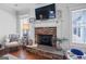 Cozy living room featuring a stone fireplace and classic furnishings at 100 Chantilly Ln, Fayetteville, GA 30215