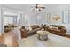 Open living room with hardwood floors, ceiling fan, and lots of natural light at 100 Chantilly Ln, Fayetteville, GA 30215