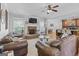 Bright living room features a stone fireplace, hardwood floors and views to kitchen and dining areas at 100 Chantilly Ln, Fayetteville, GA 30215