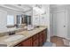 Well-lit bathroom with double vanities, granite countertops, wood cabinets, and a view of the shower and tub area at 100 Chantilly Ln, Fayetteville, GA 30215