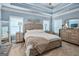 Calming bedroom features a tray ceiling, light blue walls, neutral-toned furniture, plush carpet, and natural light at 100 Chantilly Ln, Fayetteville, GA 30215