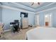 Spacious bedroom featuring blue walls, a ceiling fan, a work desk, dresser, and comfortable carpet at 100 Chantilly Ln, Fayetteville, GA 30215