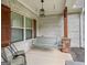 Charming covered porch features a swing and chairs, perfect for relaxing outdoors at 100 Chantilly Ln, Fayetteville, GA 30215