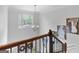 The staircase includes a beautiful banister and wedding photographs on the wall at 100 Chantilly Ln, Fayetteville, GA 30215