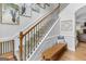 Detailed staircase with wood and wrought iron detailing, carpeted stairs, and hardwood flooring at 100 Chantilly Ln, Fayetteville, GA 30215