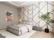 Modern bedroom with a geometric accent wall, neutral bedding, pendant lighting and a decorative plant at 2702 Antioch Ne St, Conyers, GA 30013
