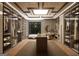 Custom walk-in closet with glass door cabinets, ample shelving, storage island, window and vanity at 2702 Antioch Ne St, Conyers, GA 30013