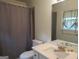 Bathroom featuring a white vanity, mirror, toilet, and shower with curtain at 1611 Cherry Hill Sw Ct, Conyers, GA 30094