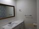 Bright bathroom with white vanity, quartz countertop, framed mirror, and chrome towel bars at 1611 Cherry Hill Sw Ct, Conyers, GA 30094