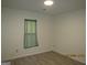 Neutral bedroom featuring vinyl floors, recessed lighting, and a window with light-blocking curtains at 1611 Cherry Hill Sw Ct, Conyers, GA 30094