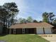 Charming single-story home with a well-maintained lawn and attached two-car garage at 1611 Cherry Hill Sw Ct, Conyers, GA 30094