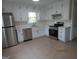 Bright kitchen with stainless steel appliances and white cabinets, offering ample counter space at 1611 Cherry Hill Sw Ct, Conyers, GA 30094