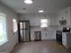 Bright kitchen with stainless steel appliances and white cabinets, offering ample counter space at 1611 Cherry Hill Sw Ct, Conyers, GA 30094