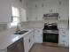 Kitchen featuring stainless steel oven and updated white cabinets at 1611 Cherry Hill Sw Ct, Conyers, GA 30094