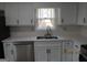 Close-up of kitchen featuring updated white cabinets and a stainless steel sink at 1611 Cherry Hill Sw Ct, Conyers, GA 30094