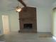 Cozy living room featuring a brick fireplace, ceiling fan, and light vinyl floors at 1611 Cherry Hill Sw Ct, Conyers, GA 30094