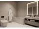 Modern bathroom featuring a sleek bathtub, illuminated mirror, stylish sink, and toilet for a spa-like experience at 2700 Antioch Ne St, Conyers, GA 30013