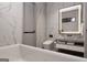 Sleek bathroom featuring a soaking tub, marble tile, and modern fixtures at 2700 Antioch Ne St, Conyers, GA 30013