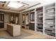 Spacious walk-in closet featuring custom shelving, organized storage, and a center island for optimal organization at 2700 Antioch Ne St, Conyers, GA 30013