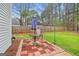Cozy patio area with a table, chairs, and umbrella in a fenced backyard at 240 Sturgess Run, Sharpsburg, GA 30277