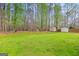 Spacious backyard with two storage sheds, wooden privacy fence, and mature trees at 240 Sturgess Run, Sharpsburg, GA 30277