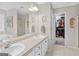 Bathroom featuring a double sink vanity, and a walk-in shower closet at 240 Sturgess Run, Sharpsburg, GA 30277