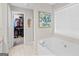 Bathroom with a soaking tub, natural light, and an open closet at 240 Sturgess Run, Sharpsburg, GA 30277
