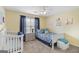 Bright bedroom with a crib, single bed, and plenty of natural light at 240 Sturgess Run, Sharpsburg, GA 30277