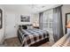 Bedroom with checkered bedding, ceiling fan, and a window allowing natural light at 240 Sturgess Run, Sharpsburg, GA 30277