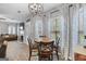 Charming dining area with stylish light fixture, wooden table, and large windows at 240 Sturgess Run, Sharpsburg, GA 30277