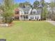 Charming two-story home with a brick facade and manicured lawn at 240 Sturgess Run, Sharpsburg, GA 30277