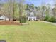 Charming two-story home with a manicured lawn at 240 Sturgess Run, Sharpsburg, GA 30277