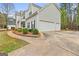 Charming home featuring a spacious three-car garage and long driveway at 240 Sturgess Run, Sharpsburg, GA 30277