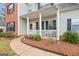 Inviting front porch with white columns and cozy seating area at 240 Sturgess Run, Sharpsburg, GA 30277