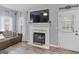 Cozy living room featuring a fireplace with mantel and access to the outdoors at 240 Sturgess Run, Sharpsburg, GA 30277
