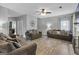 Spacious living room with comfortable seating, ceiling fan, and natural light at 240 Sturgess Run, Sharpsburg, GA 30277
