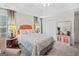 Main bedroom with a tray ceiling, a large window, and carpet flooring at 240 Sturgess Run, Sharpsburg, GA 30277