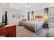 Spacious main bedroom with a tray ceiling, sitting chair, and two bedside tables at 240 Sturgess Run, Sharpsburg, GA 30277