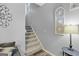Carpeted staircase with decorative wall art and stylish lighting fixture at 240 Sturgess Run, Sharpsburg, GA 30277