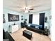 This stylish bedroom features a black futon sofa, a ceiling fan, and light blue walls, great for relaxing at 3353 Medina Dr, Jonesboro, GA 30236