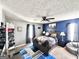 This stylish bedroom features a large bed with a patterned blanket, grey walls and blue accents at 3353 Medina Dr, Jonesboro, GA 30236